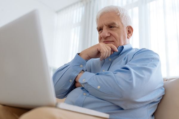 A man ponders in front of a laptop. How Do I Know I Have a Cracked Heat Exchanger?