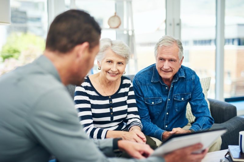 Should I Get an 80 or 95 Percent Furnace? Photo of a senior couple having a consultation with an expert.