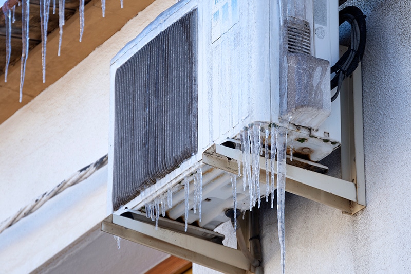 close-up of a heat pump frozen over.