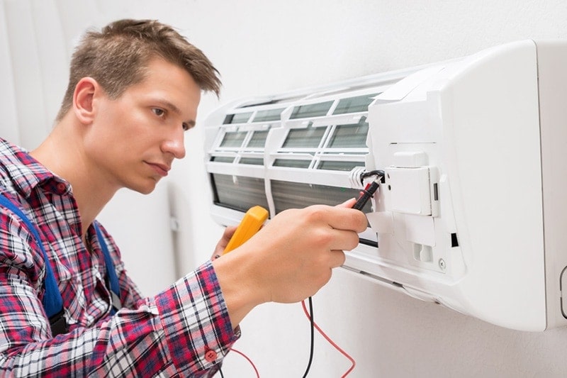 man fixing a HVAC unit